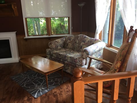 Den, w fireplace and sofa bed. Goes out to deck area in back