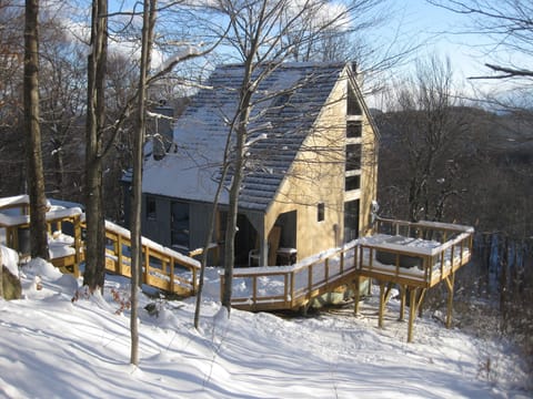 Exterior view of House. Stairs from Driveway and Deck. 