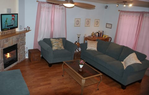 Living Room with LED TV, Fireplace, and Ceiling Fan
