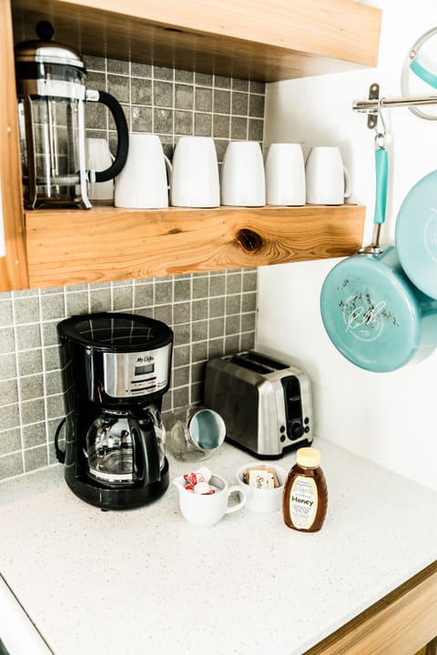 Plenty of dinnerware, coffee makings and cookware