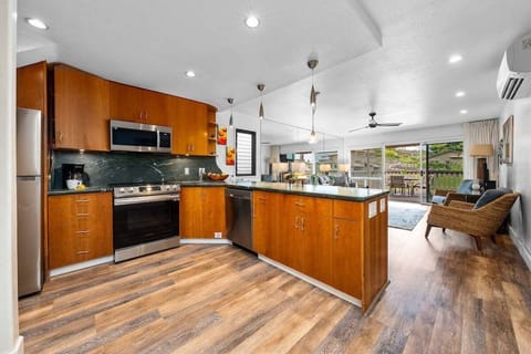 Spacious kitchen with wooden cabinetry, modern appliances, and ample counter space for cooking convenience.
