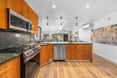 Bright kitchen featuring stainless steel appliances, sleek countertops, and open layout for easy entertaining.