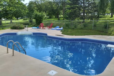 A large pool with a diving board, a nice asset for the summer!
