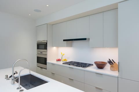 Channel your inner chef in this sleek, modern kitchen outfitted with high-end appliances and clean lines for effortless cooking and entertaining.