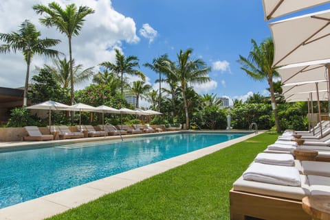 Unwind poolside with plush lounge chairs and palm-lined views—perfect for sunbathing, reading, or sipping your favorite drink.