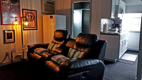 Leather motorized recliners and full fridge in background