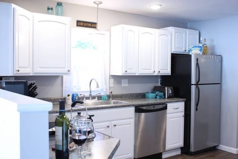 A large and comfortable kitchen - and cupboards stocked w/ dishes, pots, & pans.