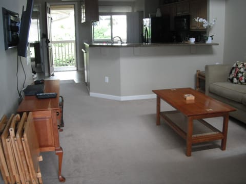 Livingroom facing kitchen and front entry door