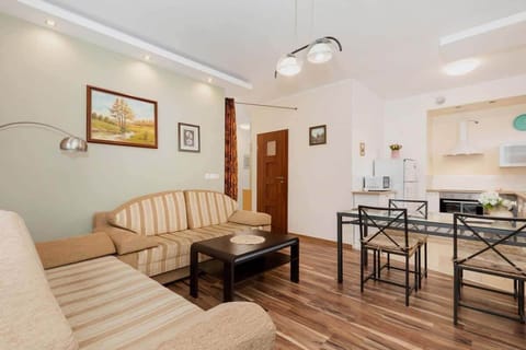 A bright living room with natural light streaming through the windows, highlighting the warm tones of the furniture.