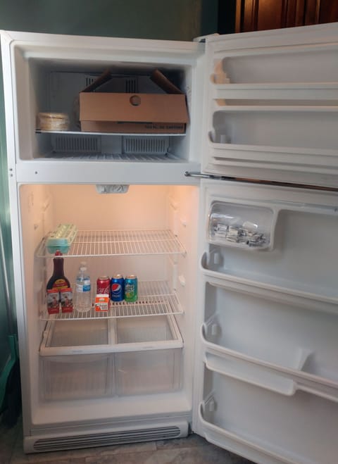 Kitchen stocked with breakfast food like waffles, eggs, milk, juice, water & pop