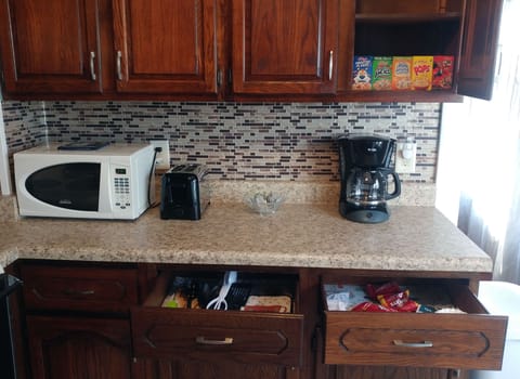Kitchen stocked with breakfast cereal, coffee, tea, and more.