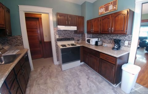Fully stocked kitchen with range/stove, dishwasher, microwave, toaster, and more