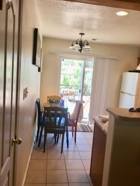 Looking into kitchen  with table that seats 4.  (2 seatings at bar area)