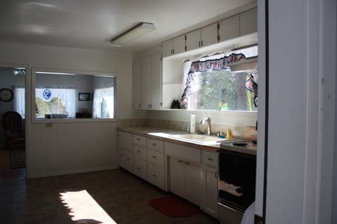 Welcome to the kitchen, fully stocked with dishes and cookware.