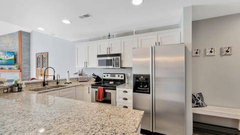 Kitchen with granite counter tops and stainless steel appliances.