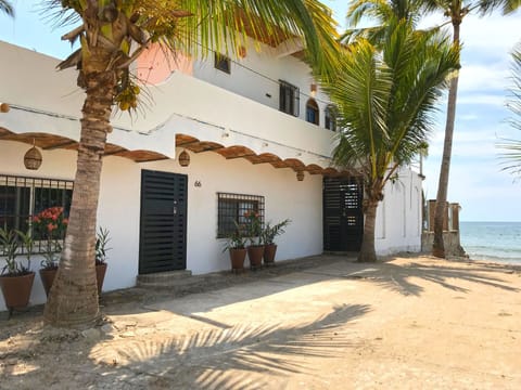 The front of La Esquina Perezosa with our new landscaping. Beach straight ahead!