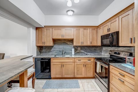 - Fully stocked kitchen with stainless steel appliances and modern granite tops
- Wood cabinetry and under cabinet lighting create a warm, functional workspace
- Everything you need for meals, snacks, and morning coffee is right here