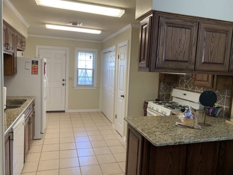 Back entry off of the kitchen leads to the patio  in the private back yard 
