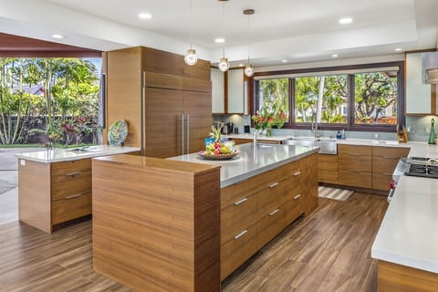 Prepare meals with ease in the modern and fully equipped kitchen with garden and pool views.