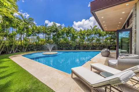 Soak up the sun by the private pool, complete with plush loungers for ultimate relaxation.
