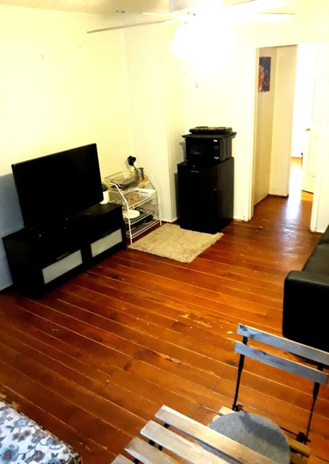 Spacious living area features a mini kitchen, sleeper sofa, and cozy dining area