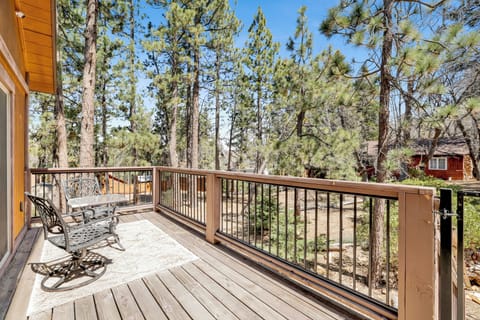 Private outdoor deck, surrounded by tall pines, perfect for relaxing under the trees after a day of adventure—enjoy peaceful forest views, fresh air, and a truly rejuvenating stay.