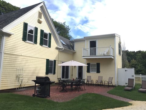 Back of the house featuring patio, grill, private balcony, outdoor shower