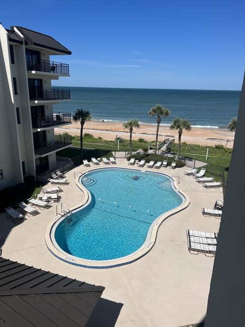 View of the pool and the beach from the balcony