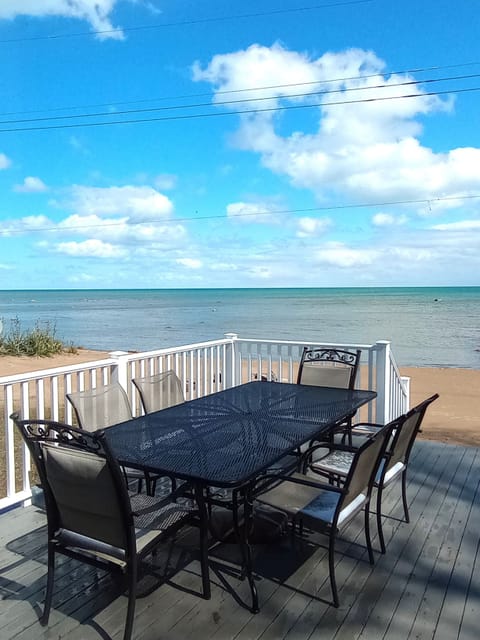 Looking out sliding glass door onto deck, beach, and Lake Huron...