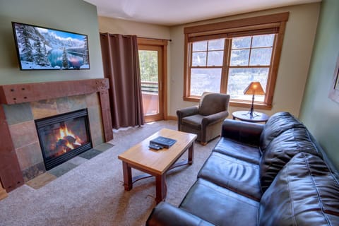 Cozy mountain condo with a flat screen TV and fireplace for cold days