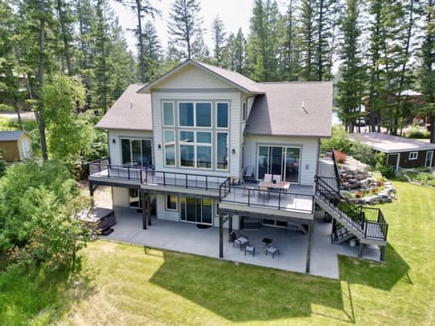 Back yard with deck, patio, eating area, hot tub