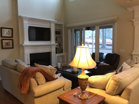 Open floor plan with new flat screen television and gas fireplace.