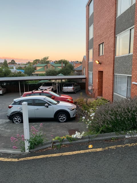 Car parking area at back of building, right next to the back door. 