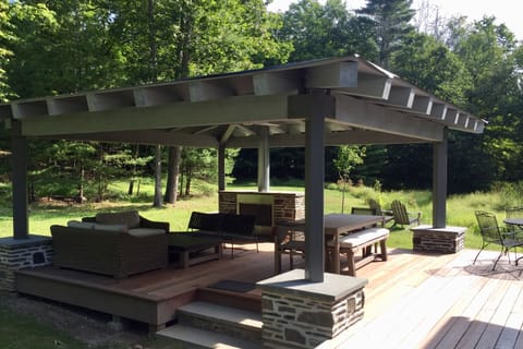 Weather-resistant outdoor room, with fireplace, ceiling fan and lighting