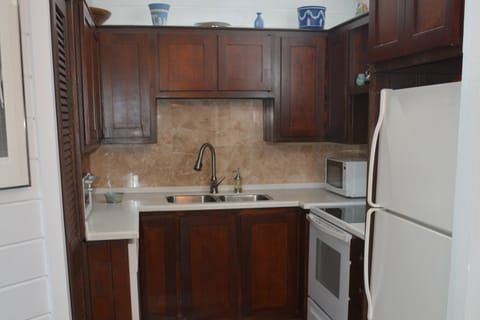 Kitchen with microwave, coffee pot, stove/oven, refrigerator and dishwisher