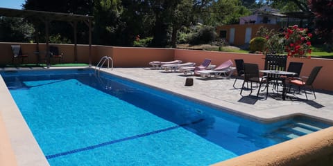 Beautiful pool  with sunbed, chirs and shade, set in delightful grounds.
