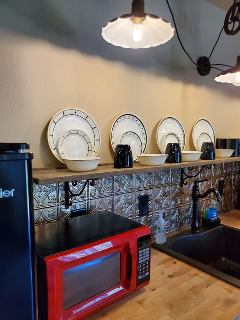 The kitchenette with a half fridge and full size stove/oven.