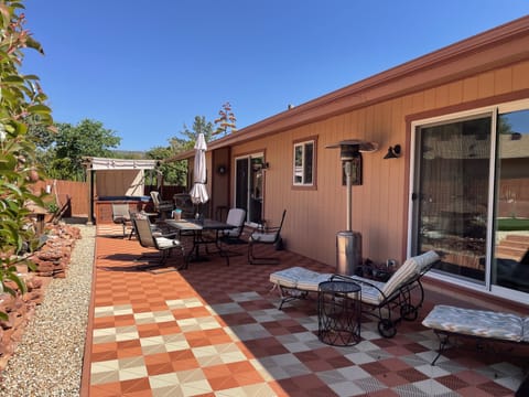 Large deck with lounge chairs, dining table and bar. Hot tub off master bedroom