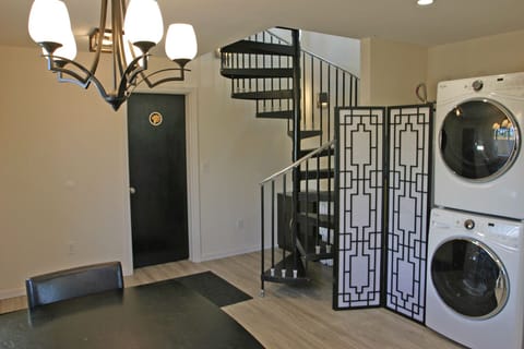 Black entry door to Shroom Suite, staircase up to Perch Suite & Summit Suite