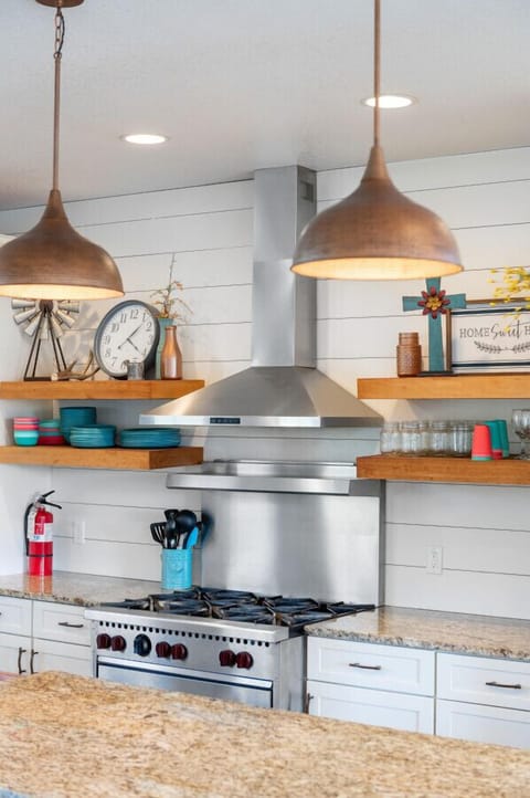 Commercial gas stove for cooking large meals in our fully stocked kitchen.