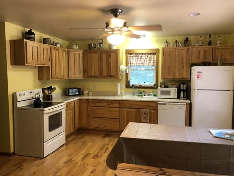 Kitchen with all major appliances and dishes.