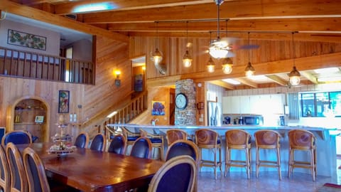 Large kitchen and dining area with barstools for 9