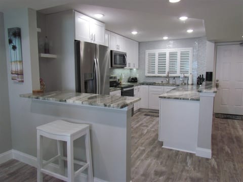 Open Concept Kitchen with Bar Stool Seating - Bar stool seating and an open floor plan to enjoy your family and friends while you're here!