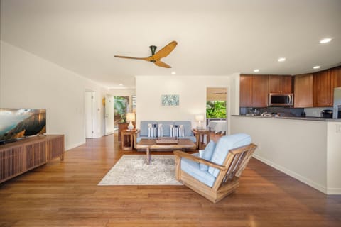 View of the living room, kitchen and bedroom on the right