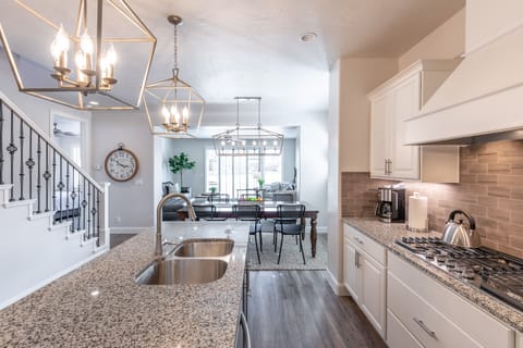 Kitchen - The Kitchen is complete with everything you will need for meal preparations including pots, pans, baking dishes, plates, cups, silverware, cutlery, and an assortment of cooking utensils.