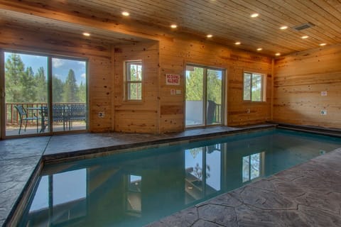 - Indoor pool retreat with wood cabin charm  
- Relaxing mountain views from sliding glass doors  
- Year-round private pool perfect for family fun