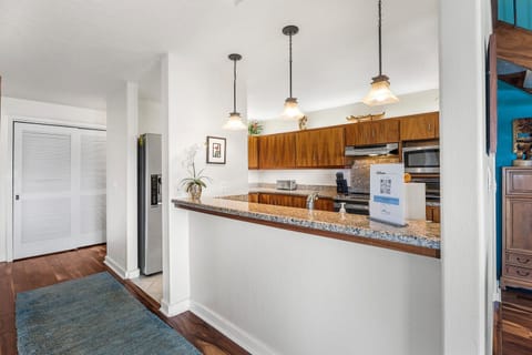 Casual breakfast bar and pendant lighting for morning coffee or quick bites.
