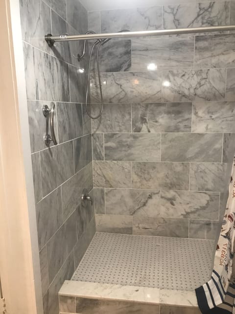 Floor to ceiling marble shower, now that’ a lot of luxury for an efficiency!
