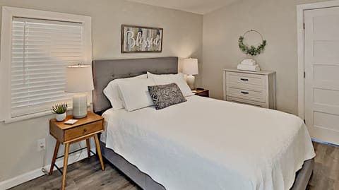 Bedroom with Queen Bed, TV, and Downtown view Patio