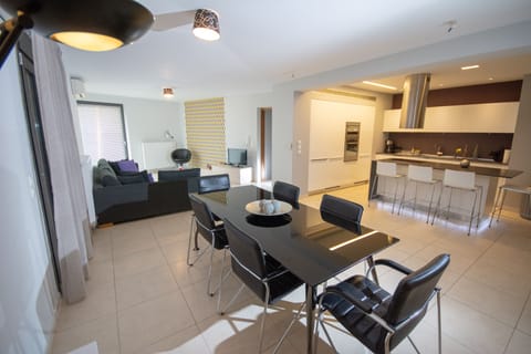 View of the kitchen, dining table and the living room